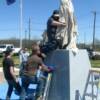 The covered statue being set in its final location in preparation for the May4th, 2013 dedication ceremony.